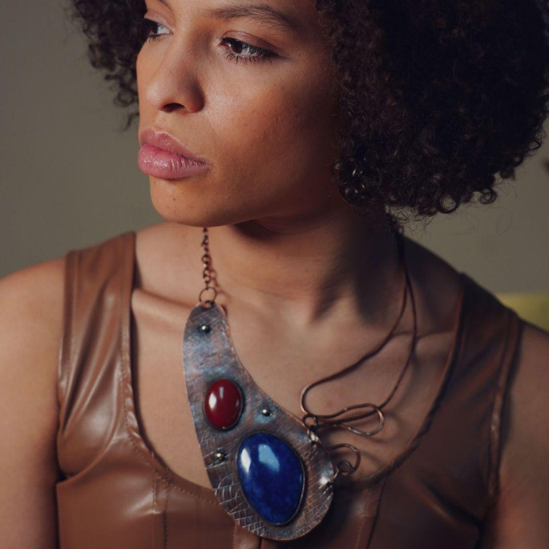 A model wearing The VOICE Statement Necklace with Lapis Lazuli, Carnelian and Copper by Junebug Jewelry Designs