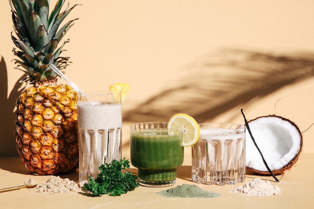Mixed drinks of Maintenance Cleanse against a beige background