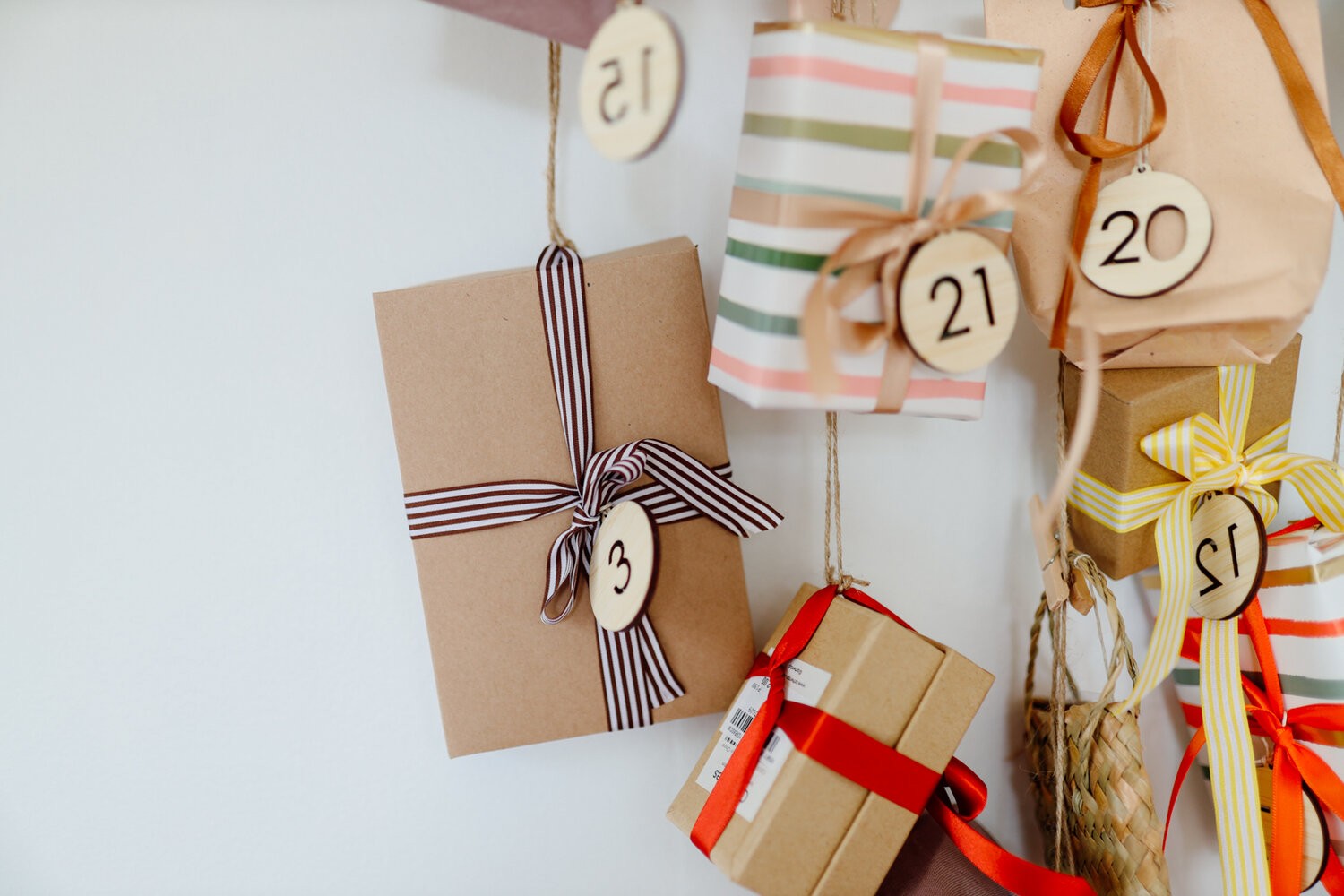 Labelled cardboard boxes are hung on the wall with beautiful ribbon wrapped around them.
