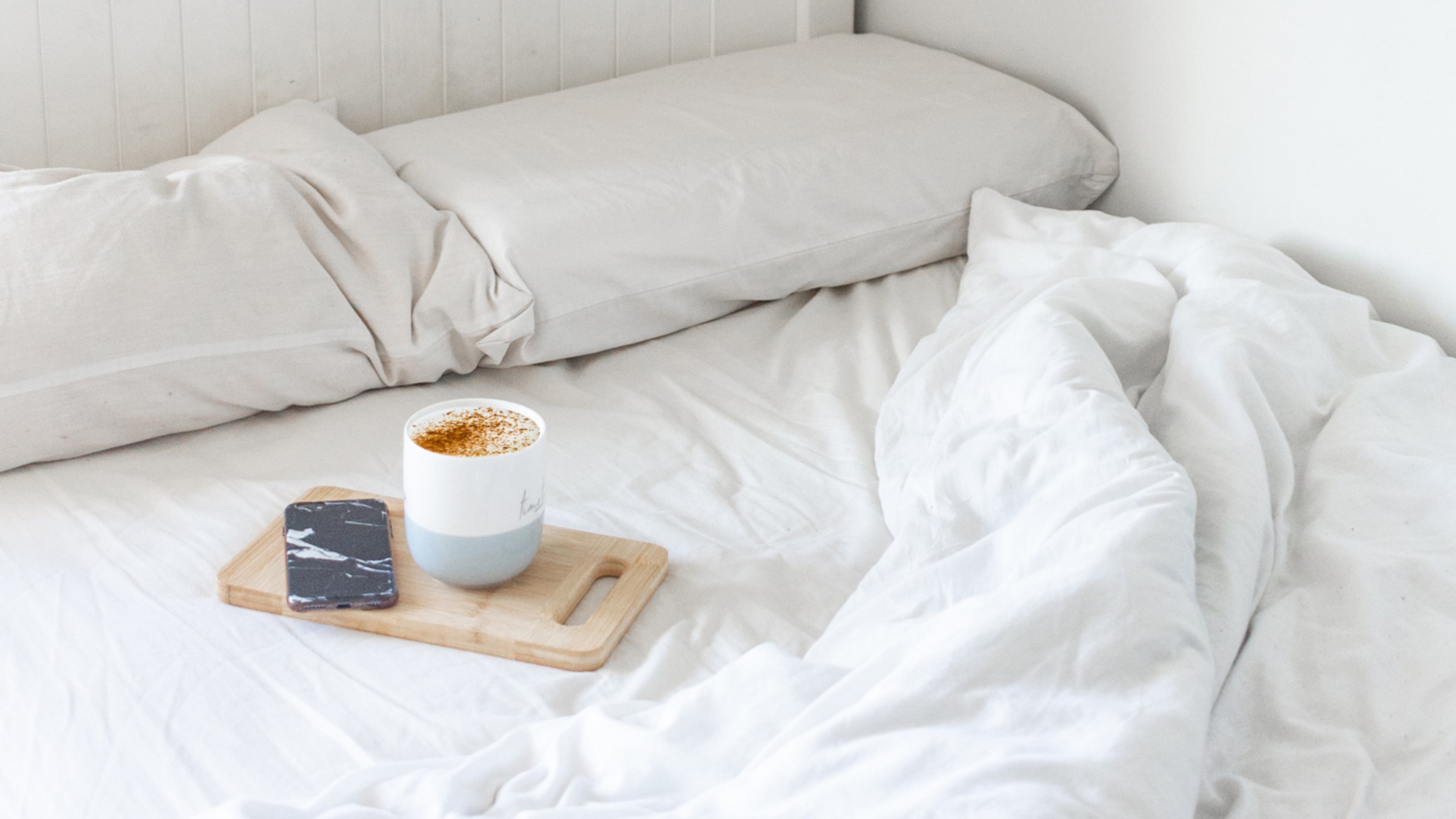 Bed with a coffee and phone