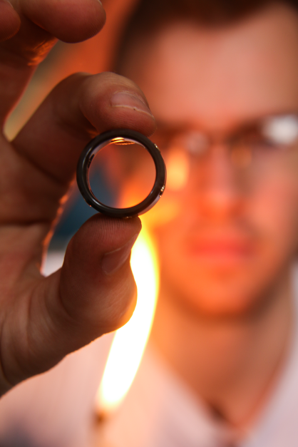 Holding a non metal wedding band.