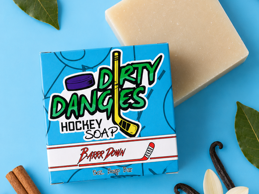 Barrr down bay rum scented hockey soap bar on a blue background with cinnamon, vanilla and bay leaves.