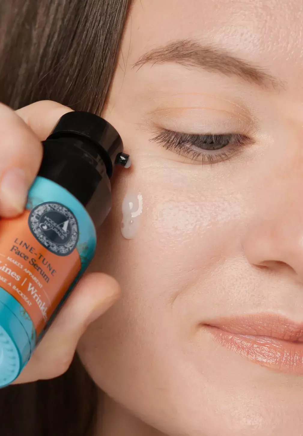 woman applying line tune on face