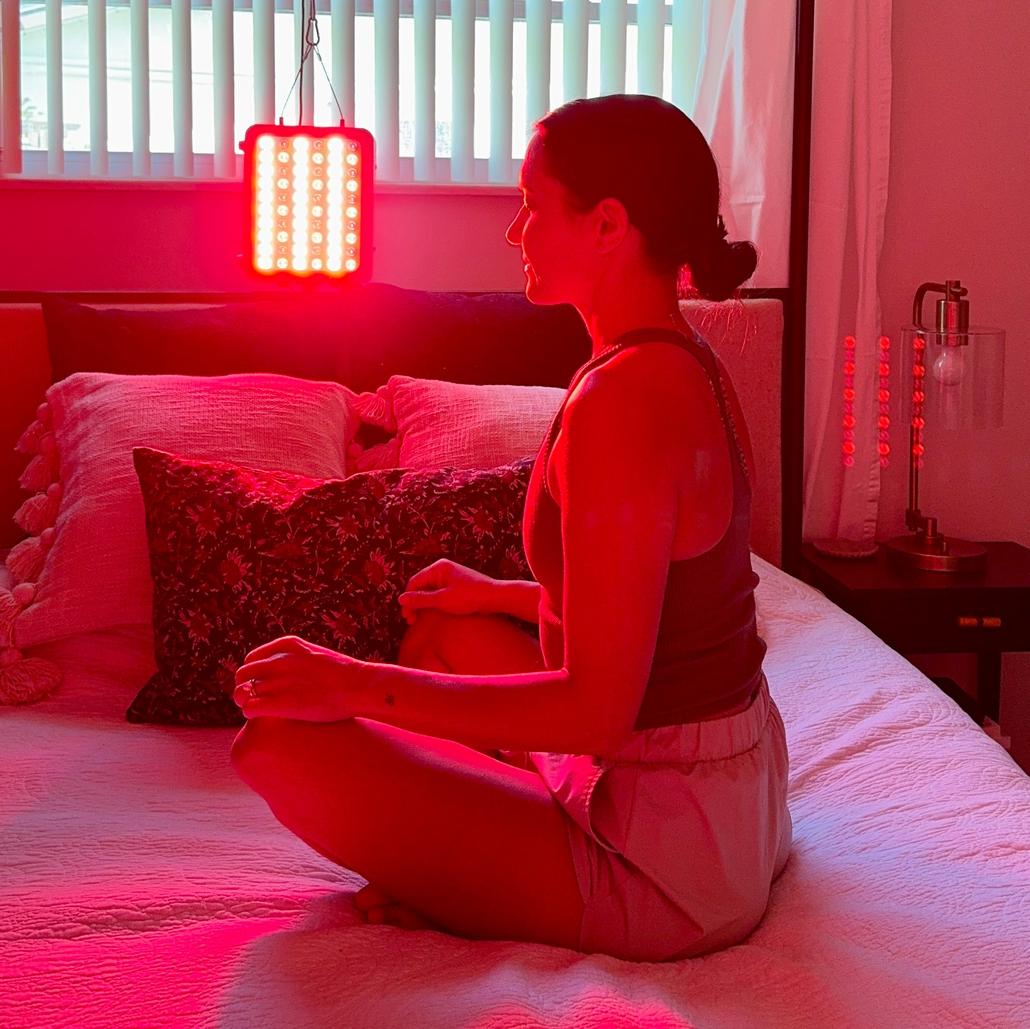 Relaxed woman enjoying her red light therapy session at home