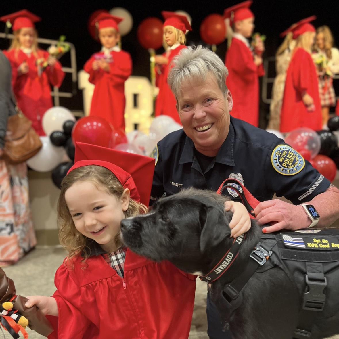 Sgt. Bo and his Handler Faye Okert with children of the Covenant School