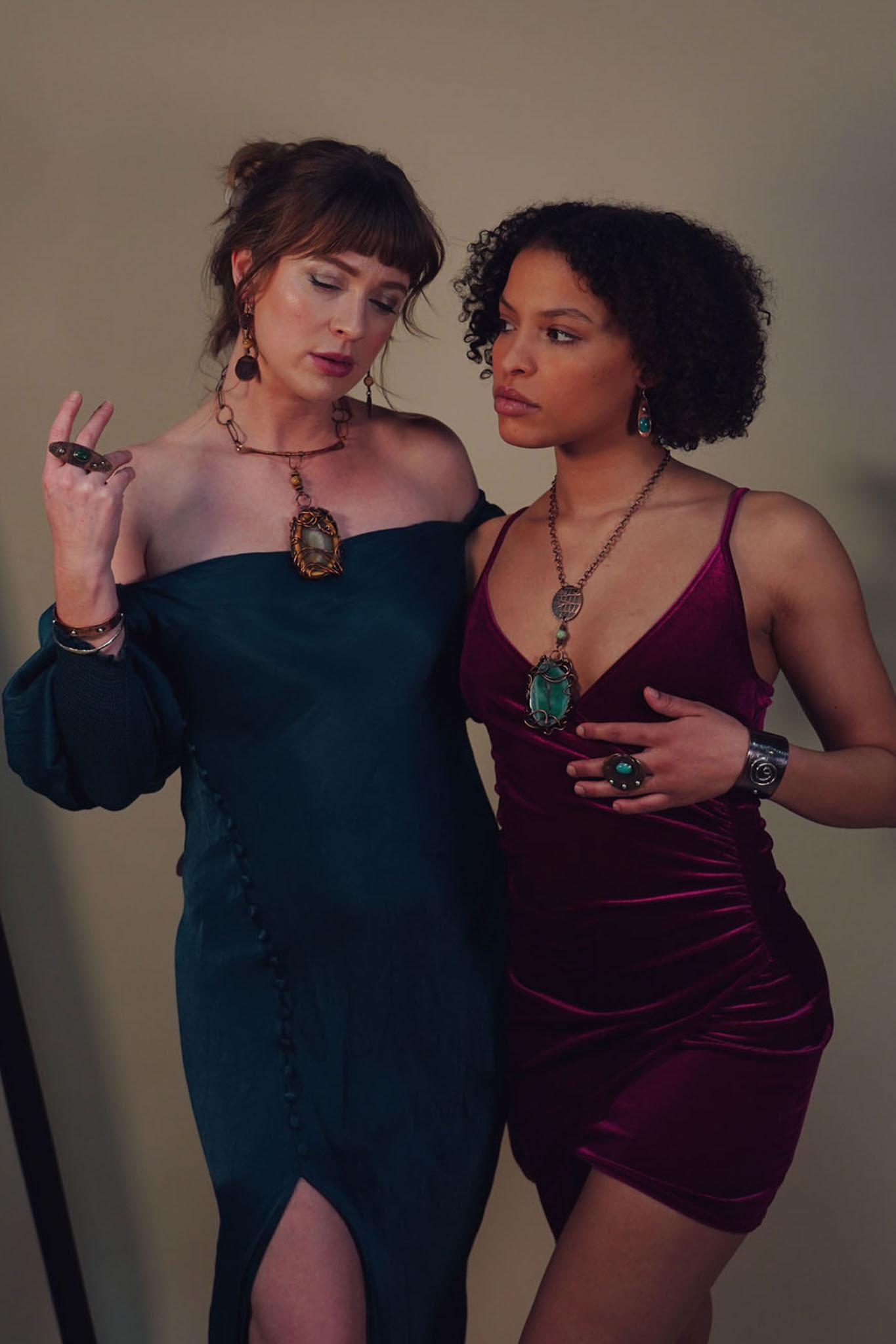 Two models wearing a wide variety of bold, statement jewelry from Junebug Jewelry Designs