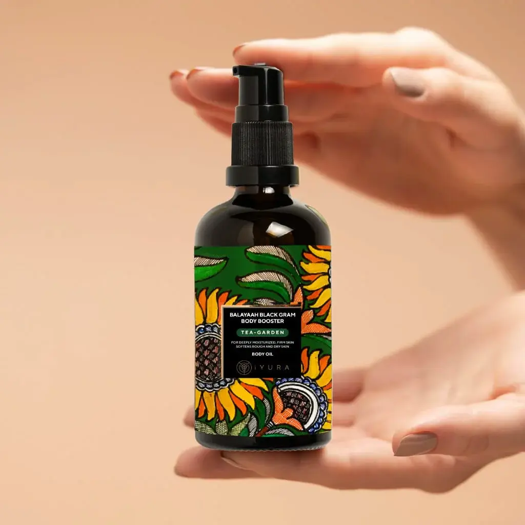 A person holding a bottle of Balaayah Black Gram Body Booster - Tea Garden Blend