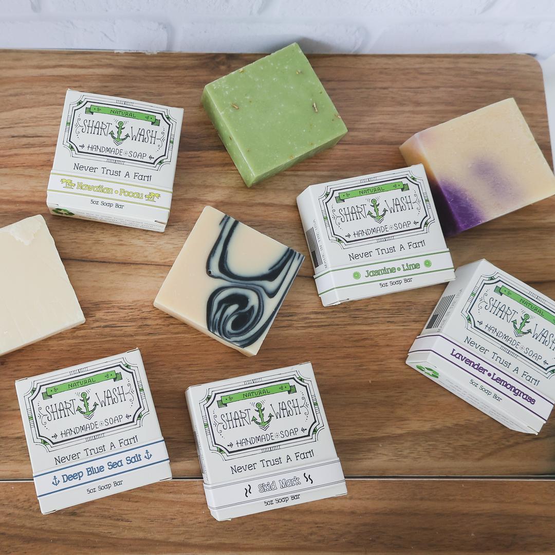 picture of a yellow bar of Hawaiian Pooau scent shart wash handmade soap on a wood background