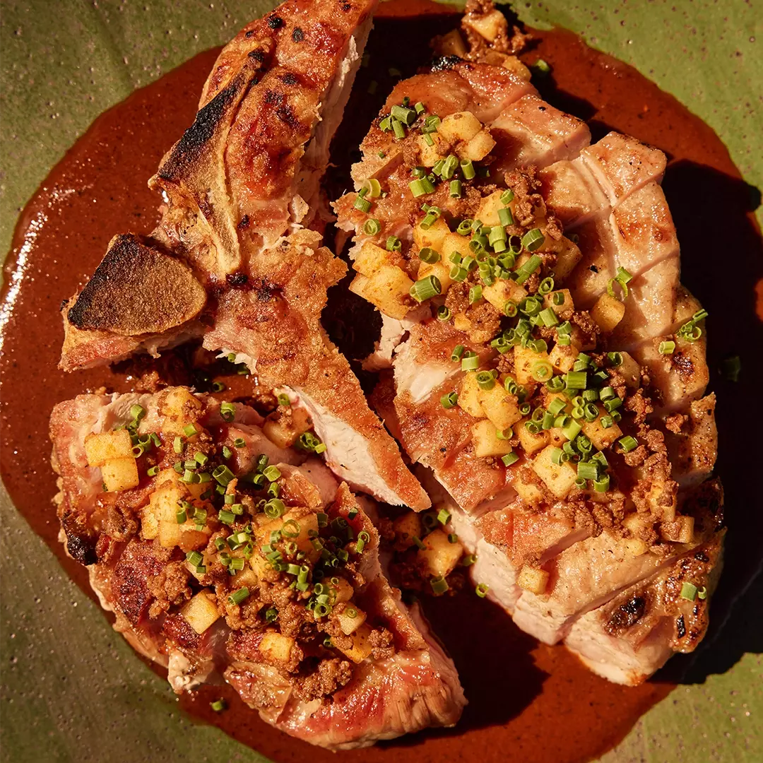 Pork Chop with Holy Moly Mole, Pickled Apple, and Nilgai Chorizo