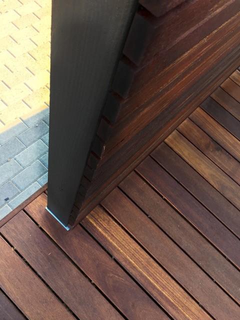 close up of the structural post anchor supporting the privacy panel posts