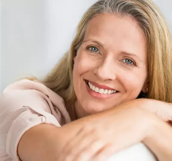 woman massaging her face and feeling relaxed