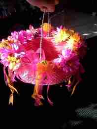 A pink gift basket decorated with flowers