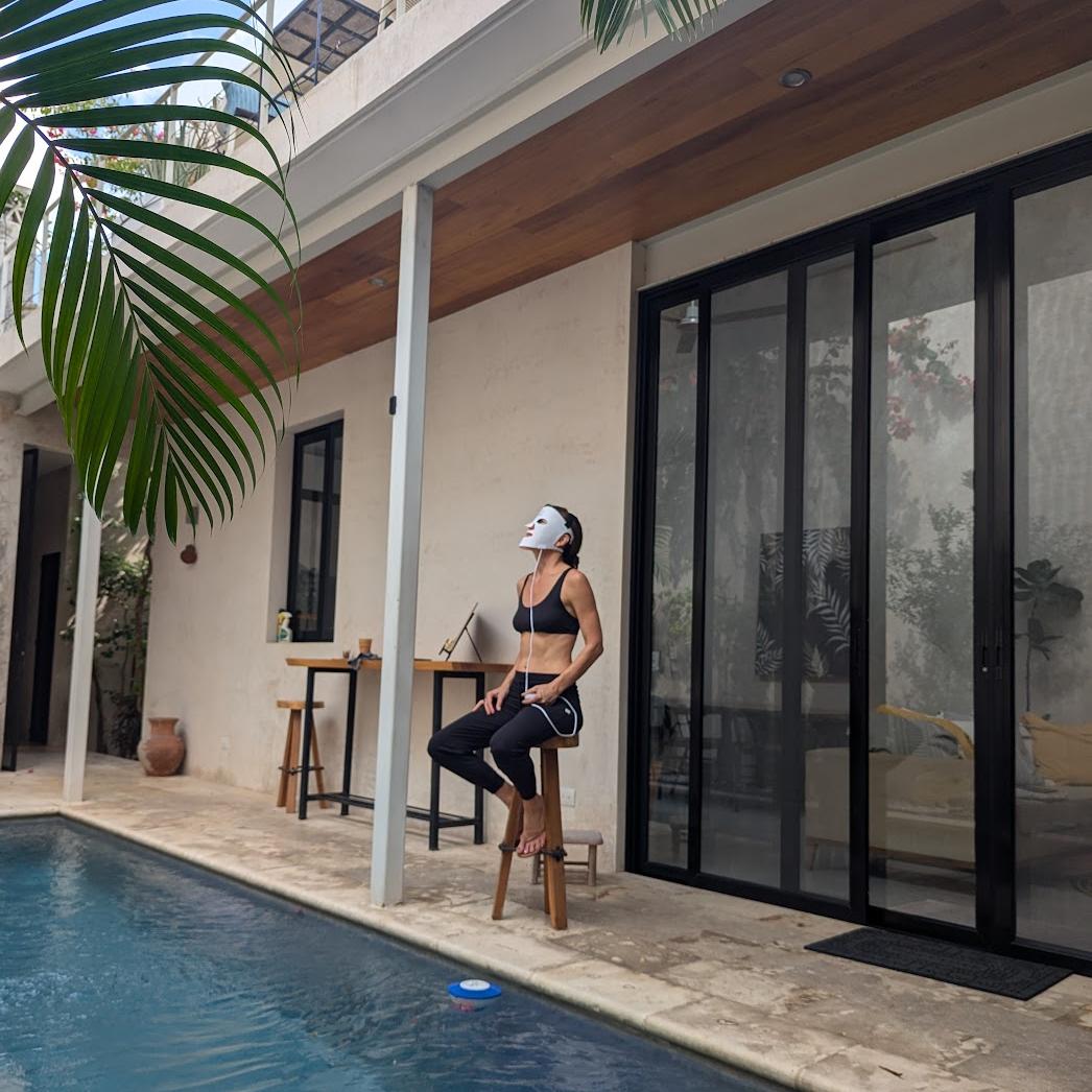 woman sitting by the pool wearing beautimate LED Mask