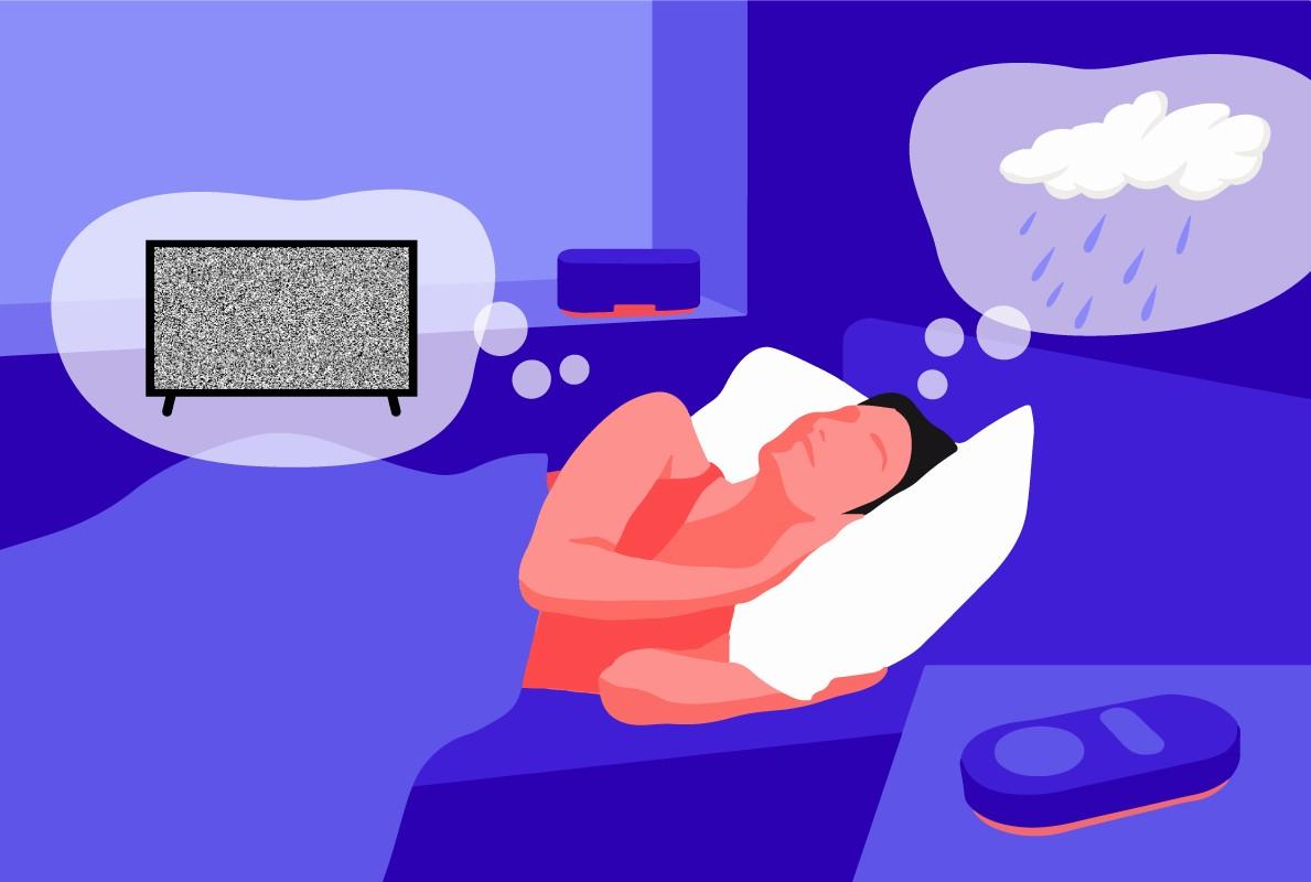 A man lying in bed relaxing with a white noise machine. There are 2 thought bubbles over his head, one containing a TV with static and the other a pink cloud with rain to represent pink noise vs white noise.