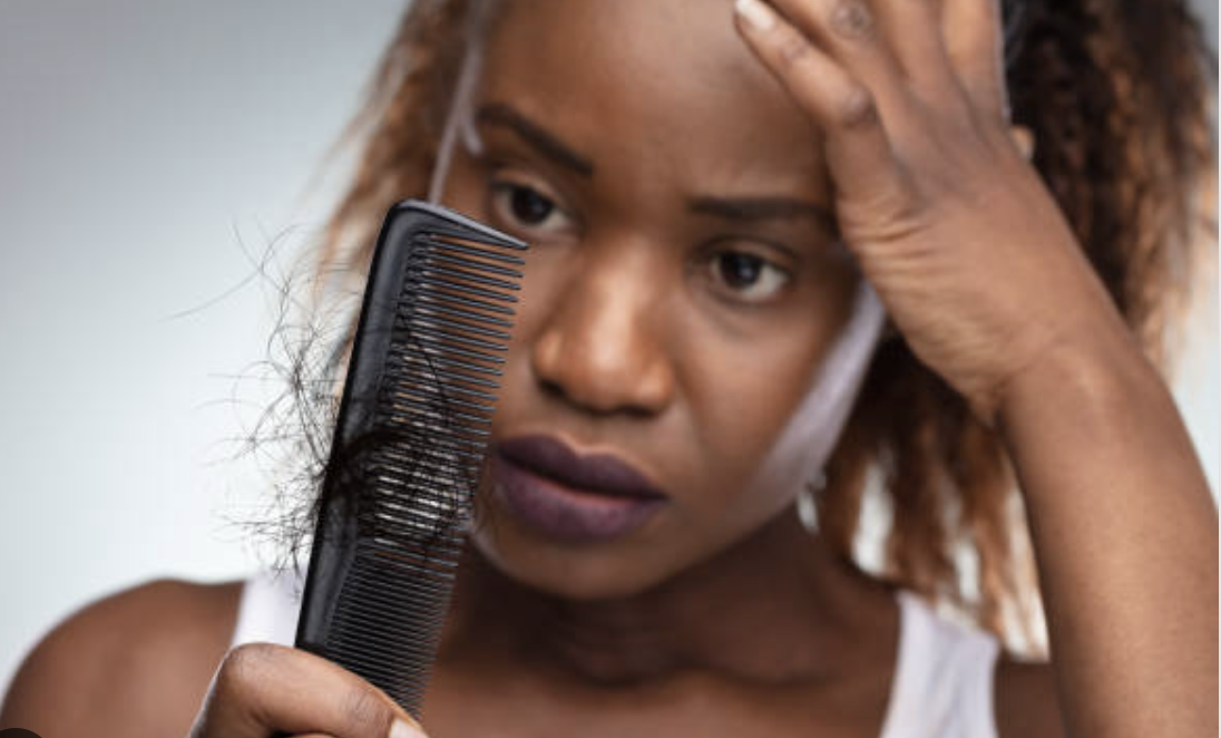 black woman combing her natural hair