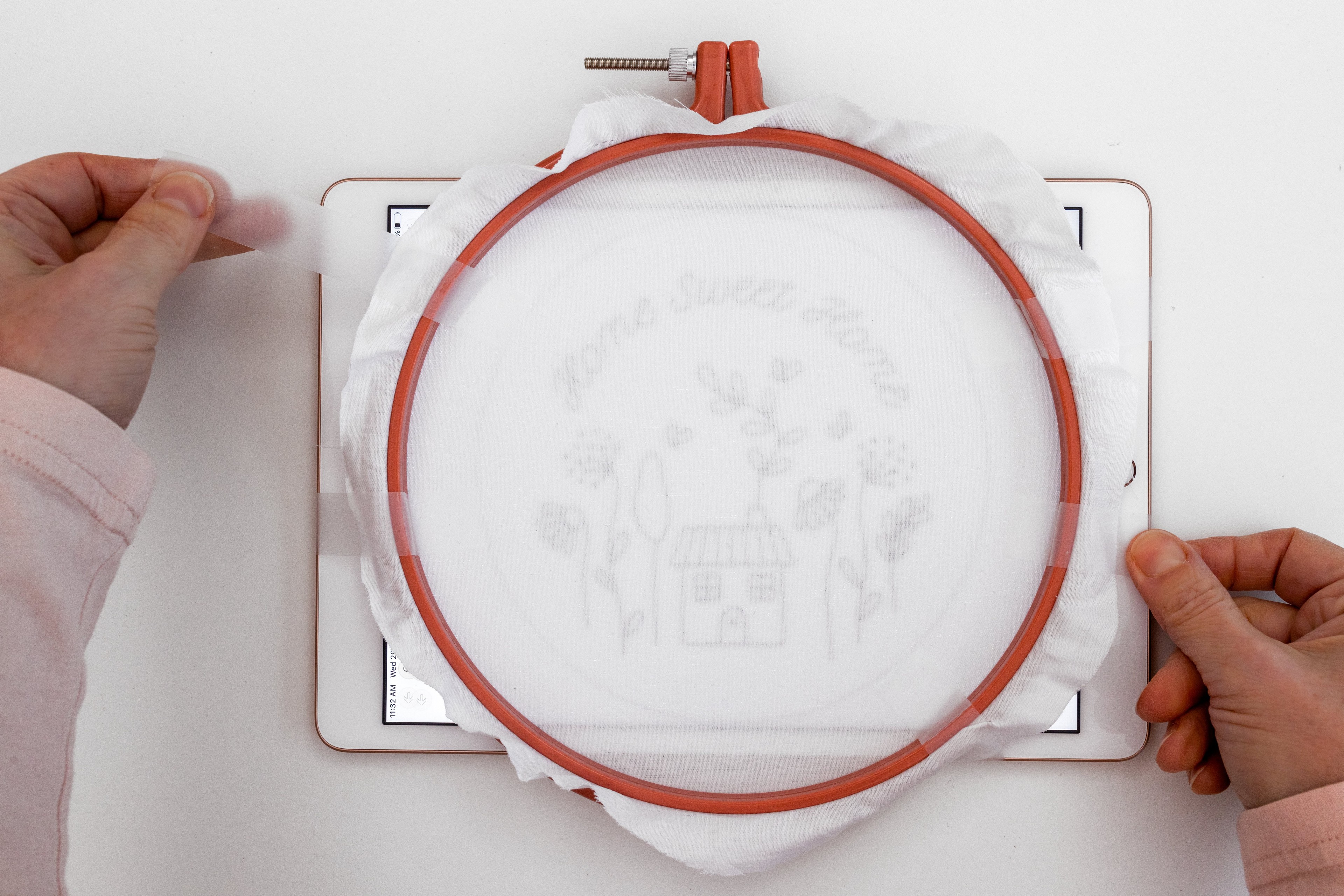 The pattern is cellotaped to the back of the hoop, which is pressed against an Ipad.