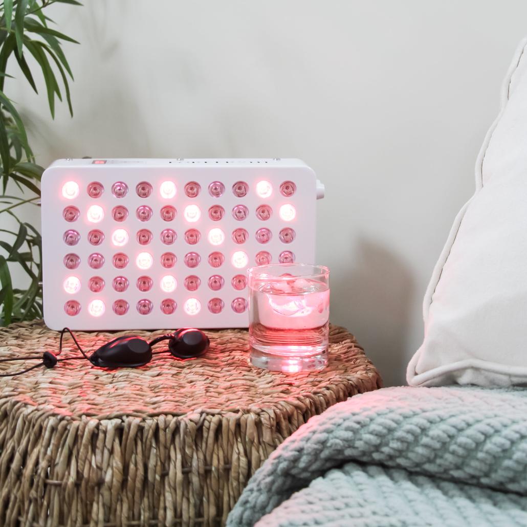 Portable Red Light Therapy Device set on a bedside table