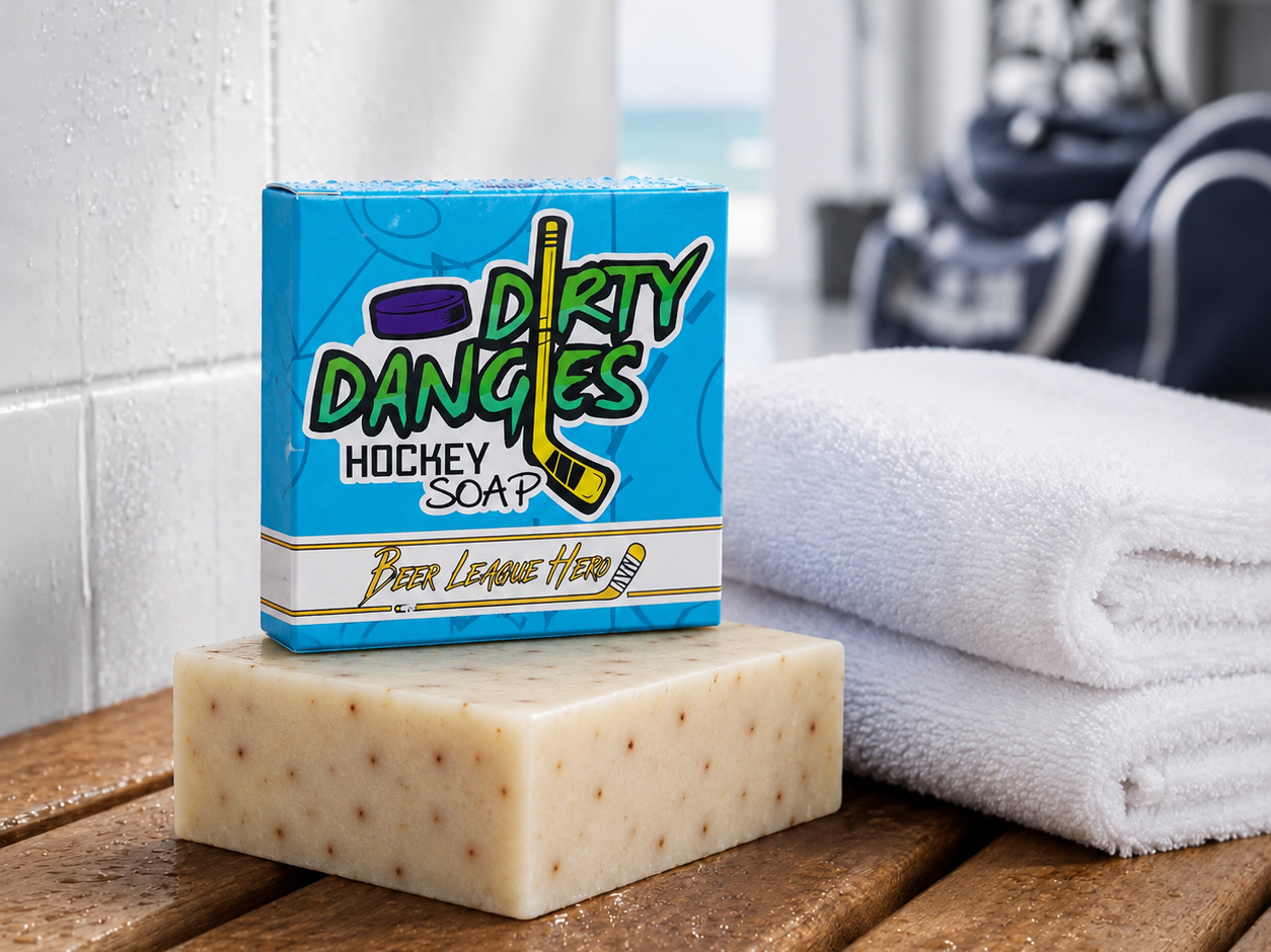 A white and orange beer league hero grapefruit pale ale soap bar with a blue soap box inside a hockey locker room