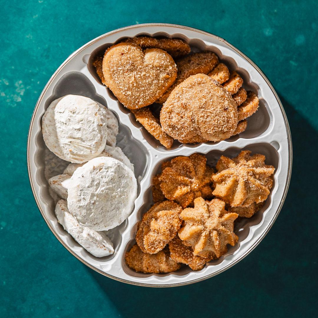 open cookie tin showing three types of mexican cookies in a 3 cavity set