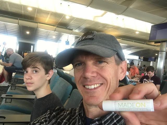 vaseline lip balm alternative man holding in airport