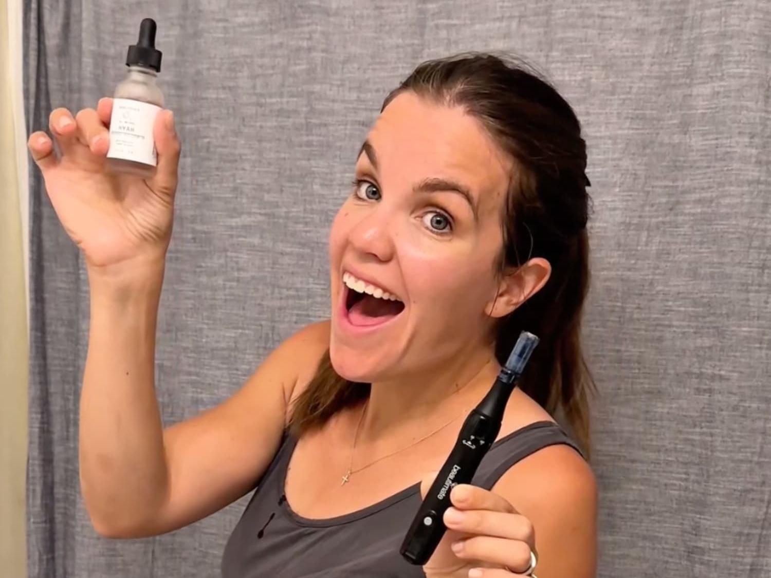 woman smiling holding microneedle pen and hyaluronic acid by beautimate