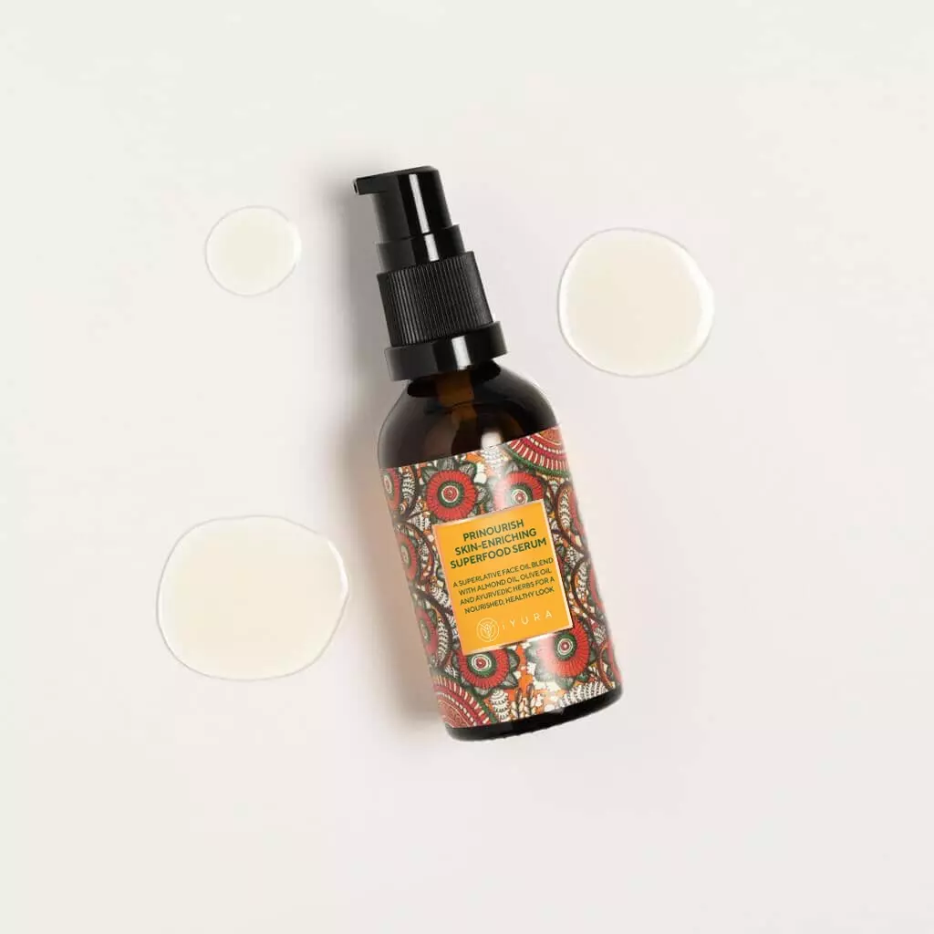 A bottle of Prinourish kept on a light color background with droops of serum around it