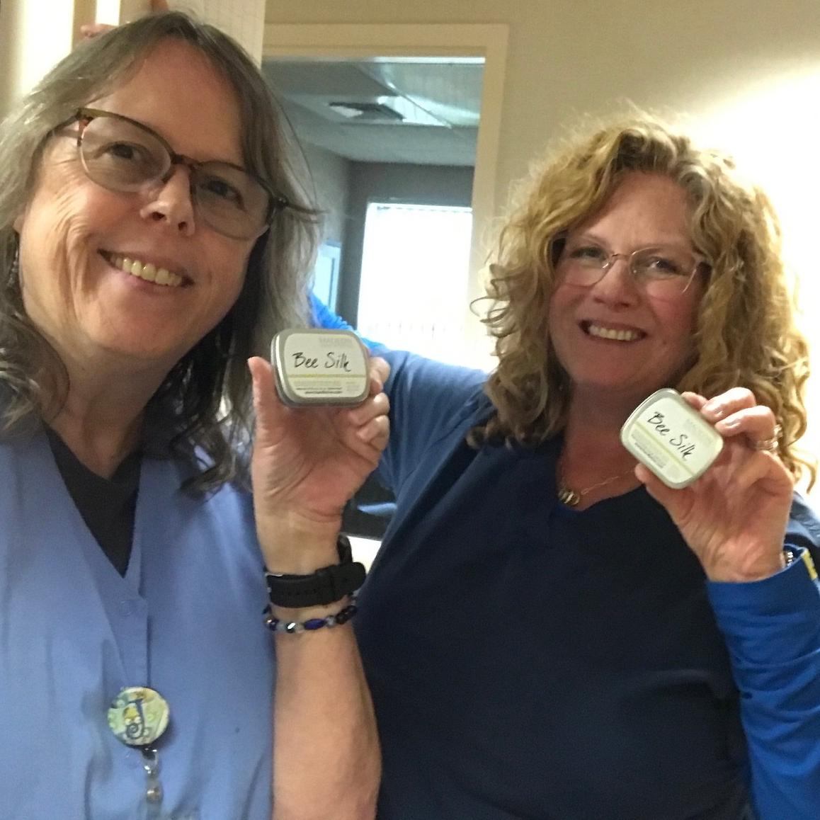 Traveling female friends holding up beesilk lotion bars