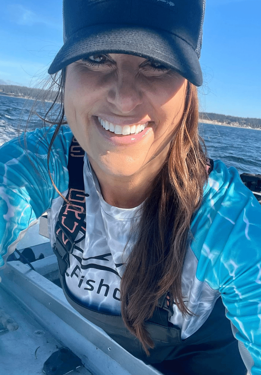 Woman wearing Fishoholic fishing shirt on a boat in the water