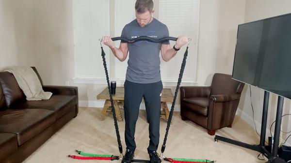 Man working out with xbar portable home gym