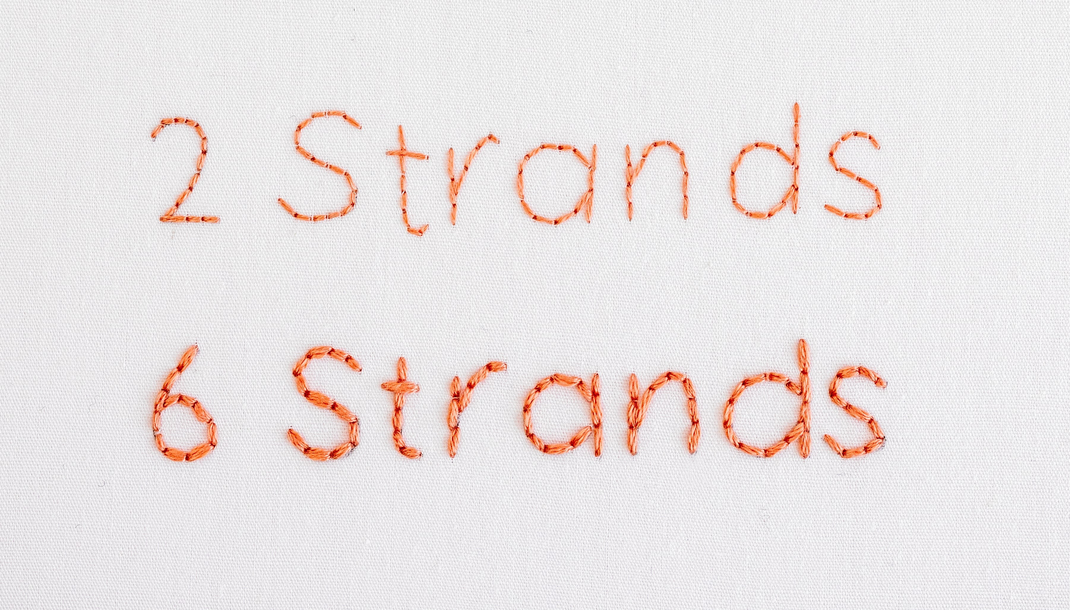 This is an image of the the word '2 strands' using two strands of floss and six strands of floss.