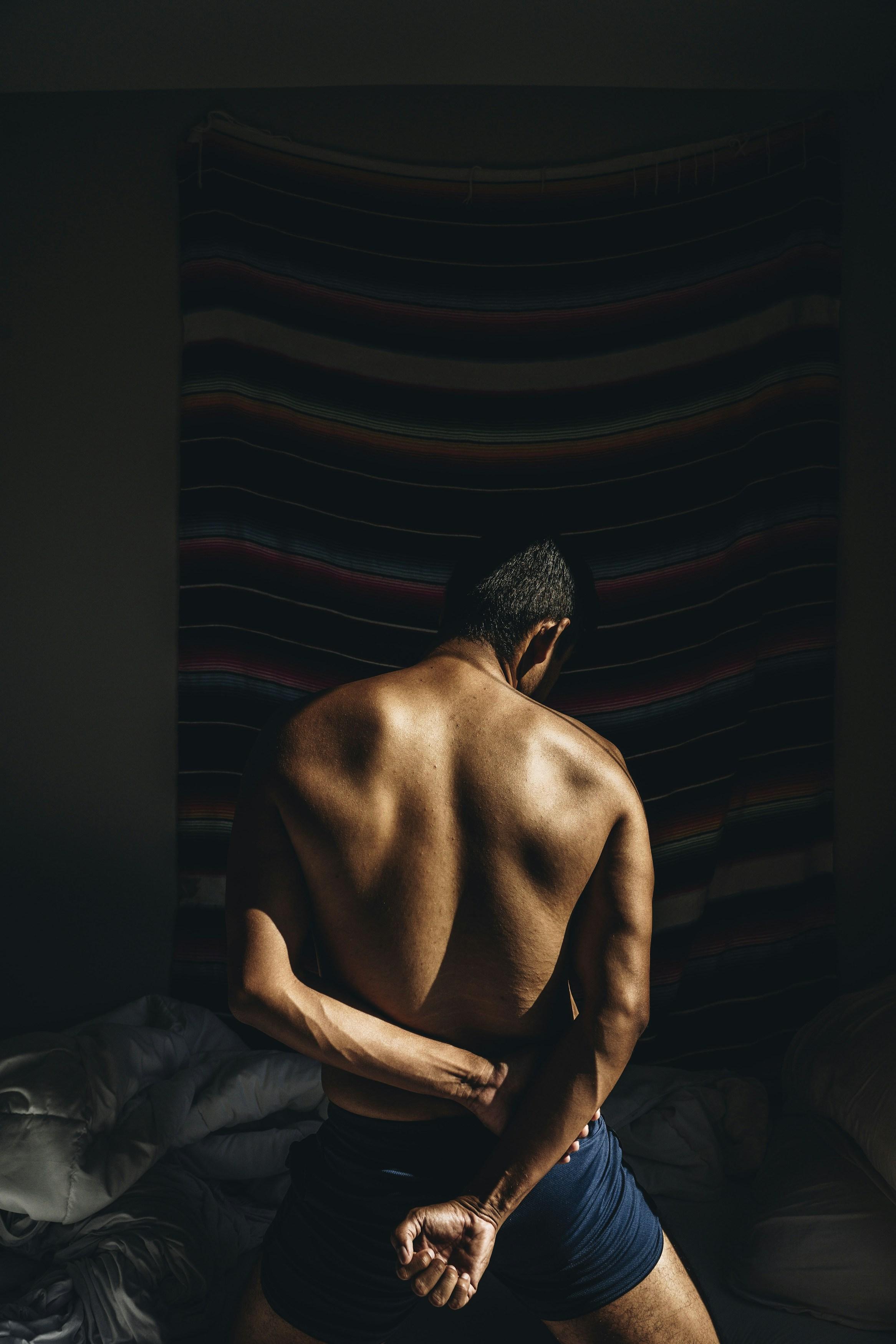 man flexing his chest muscles