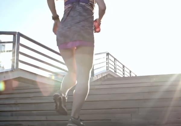 Fit Woman Running Up Stairs Outside Sunny Day