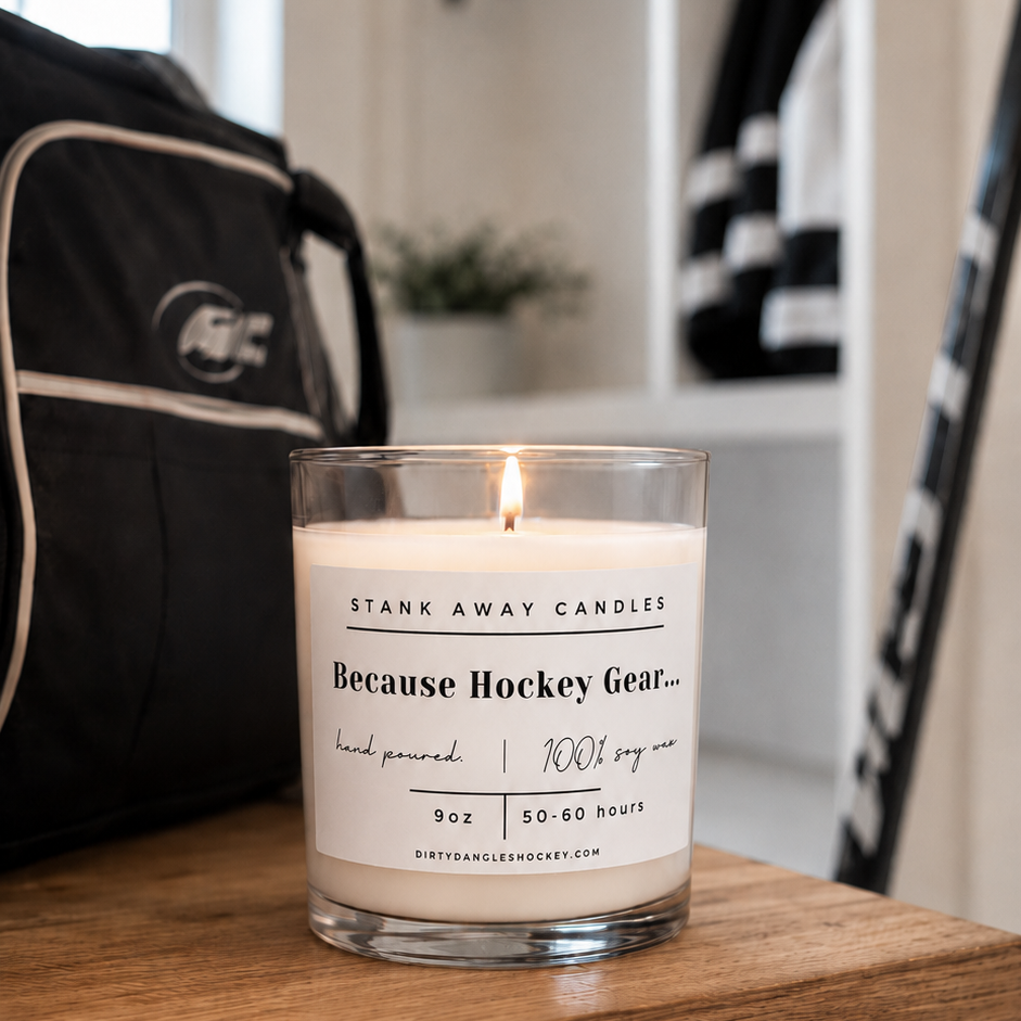 A white scented hockey candle on a wooden bench. Because Hockey Gear