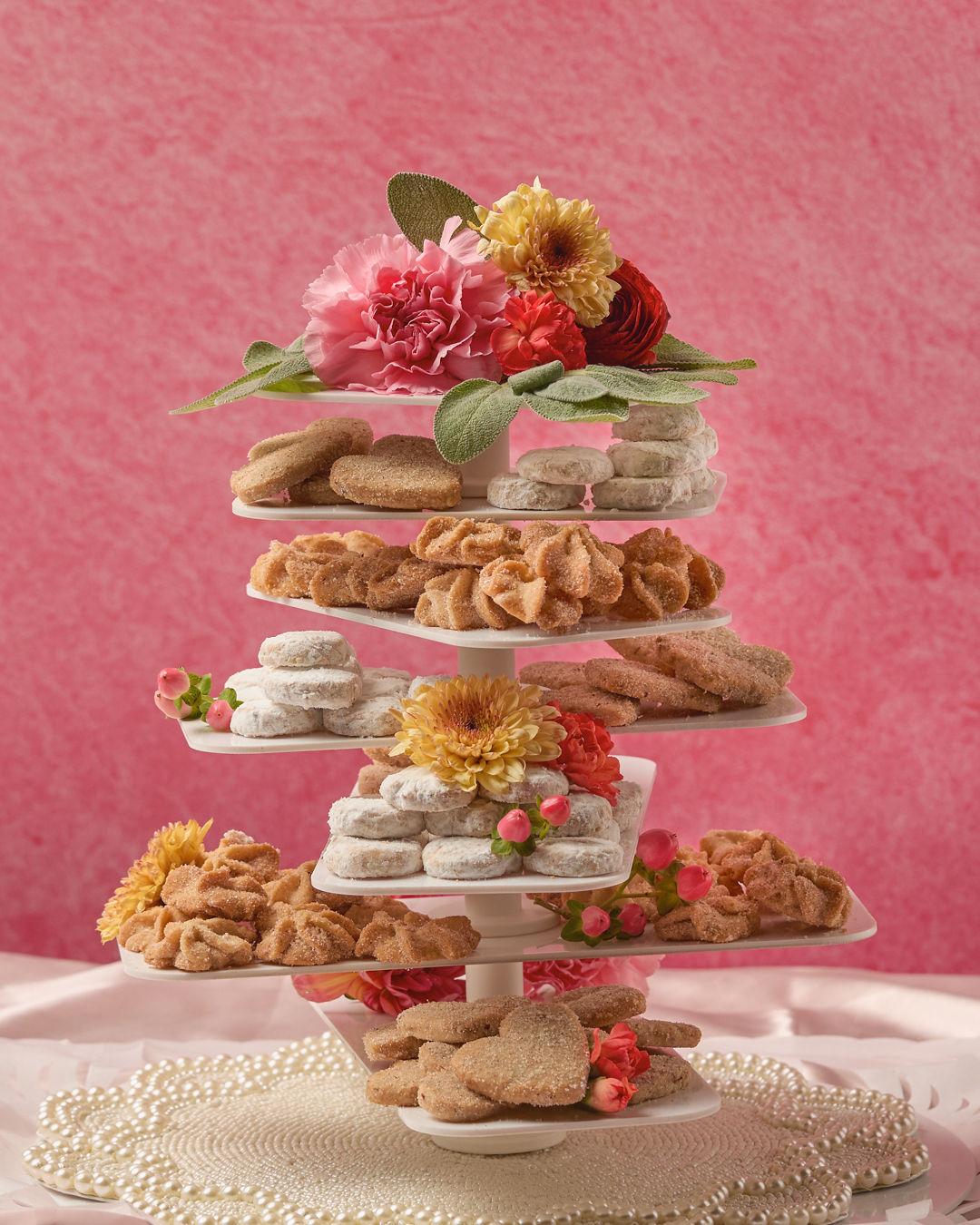 cookie tower on pink background with flowers and pearls
