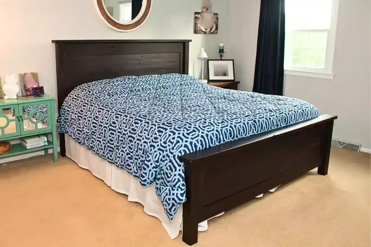Brown maple queen-size bed with clean lines and dark stain in a bright modern bedroom