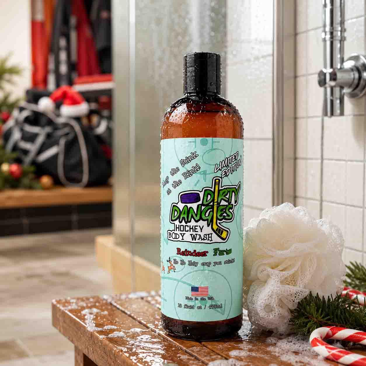 A bottle of Dangle's Hockey Body Wash in Reindeer Farts candy cane scent, on a wooden hockey locker room bench with a white loofah and holiday decorations in a shower setting.