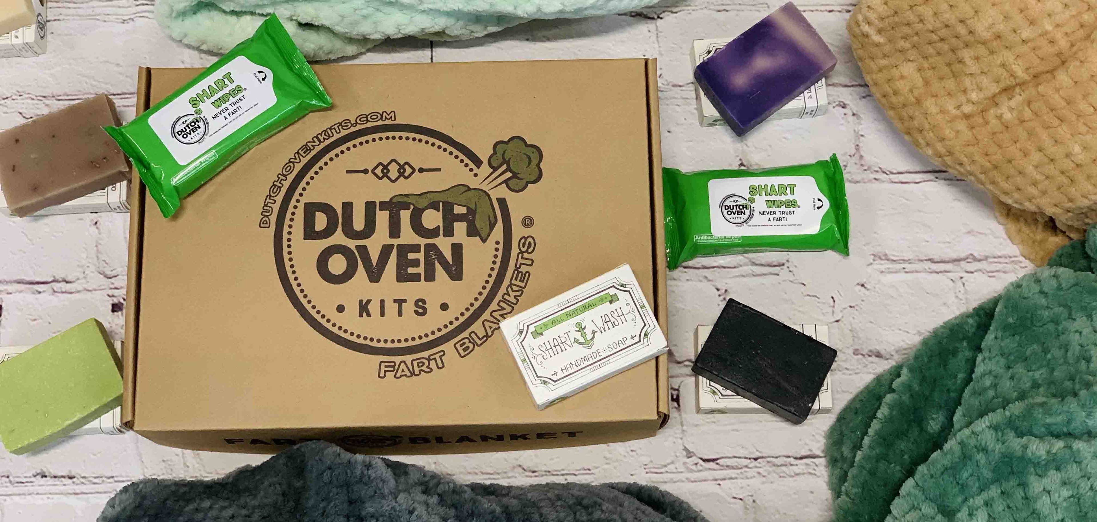 picture of a dutch oven kits box, shart wipes and shart wash soap on a brick background