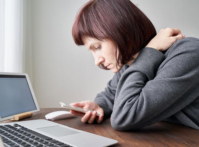 Woman staring at a screen intensely.