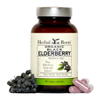 Bottle of Herbal Roots Organic Black Elderberry with a few capsules to the right and a small bunch of black elderberries on the left