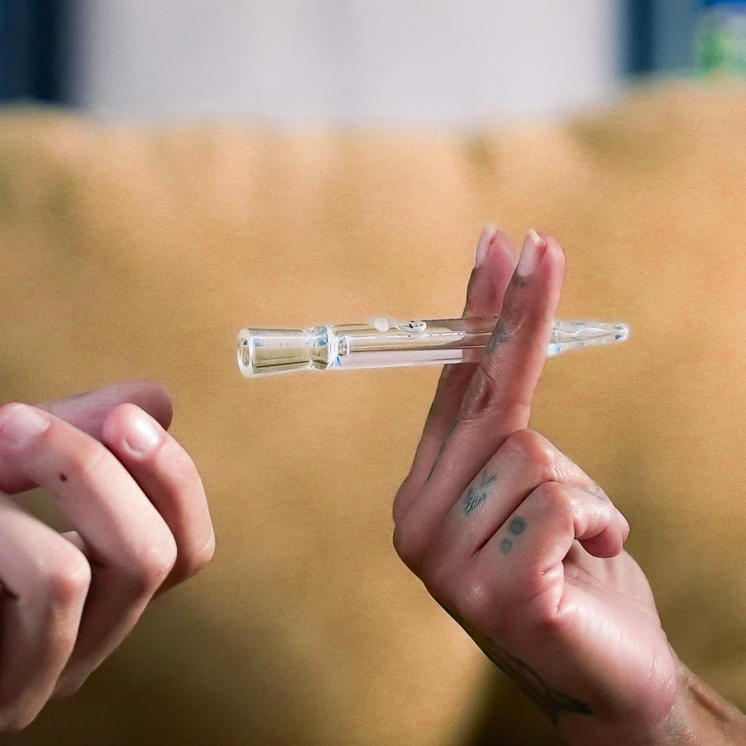 womans hands holding a one hitter