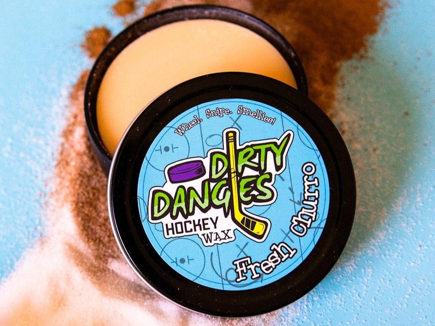 Fresh Churro Scented hockey stick wax on a blue background surrounded by cinnamon and sugar