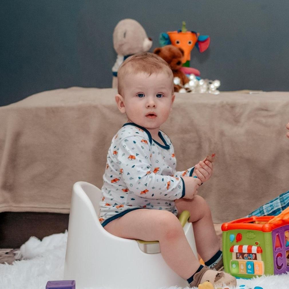 child sitting on a potty