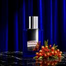 Bloodflower bottle with red bloodflower blossoms against a dark pleated curtain
