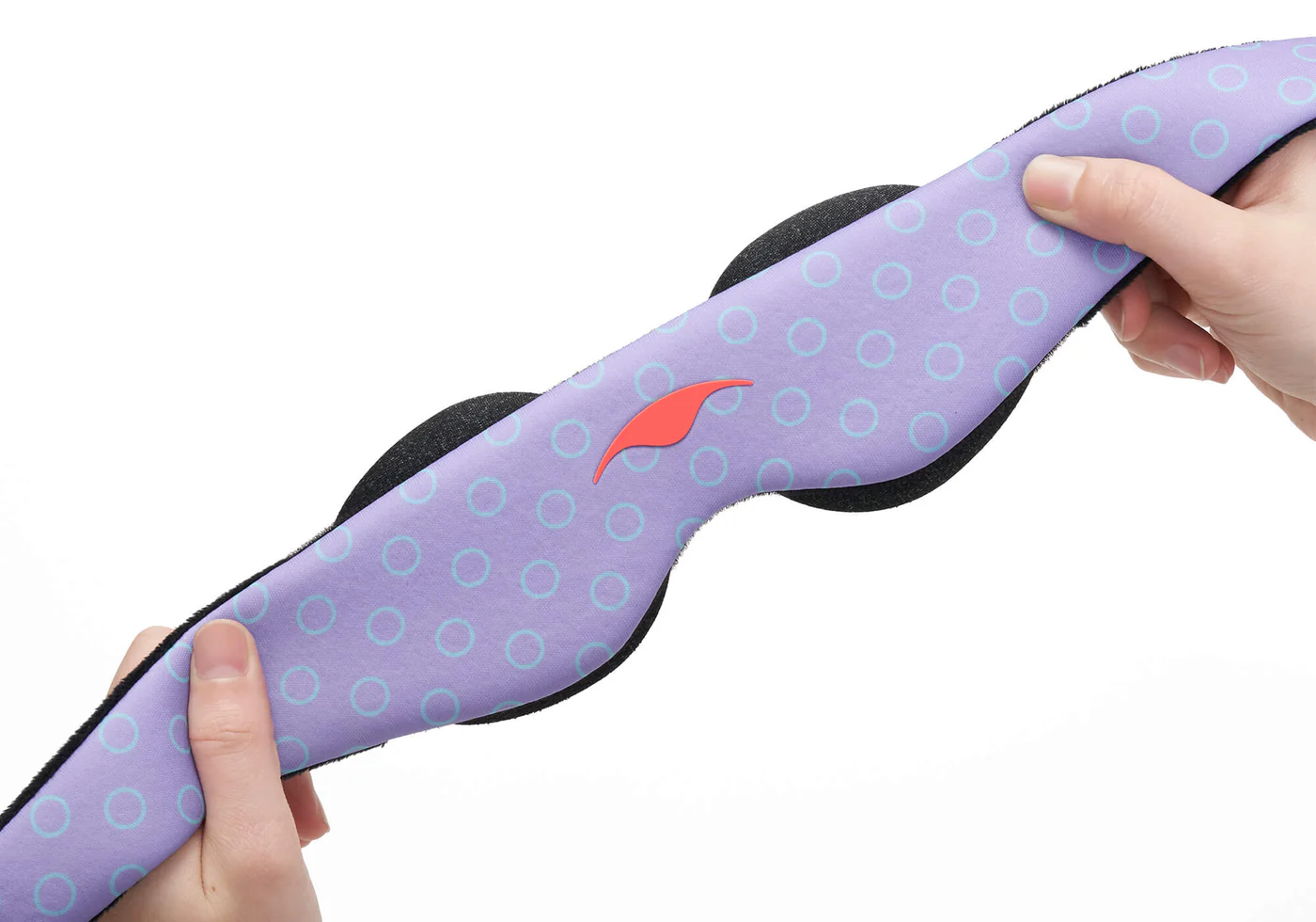 Hands squeezing the purple strap of a sleep mask for kids with eye cups attached to the interior.