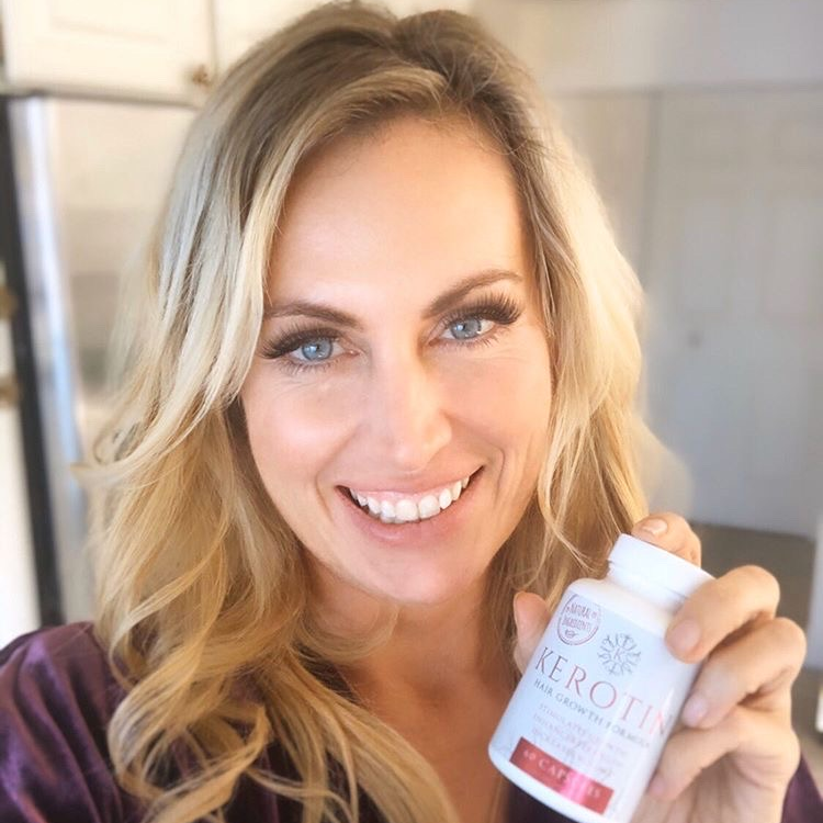 Model With Long Blond Hair Holding a Bottle of Kerotin Vitamins