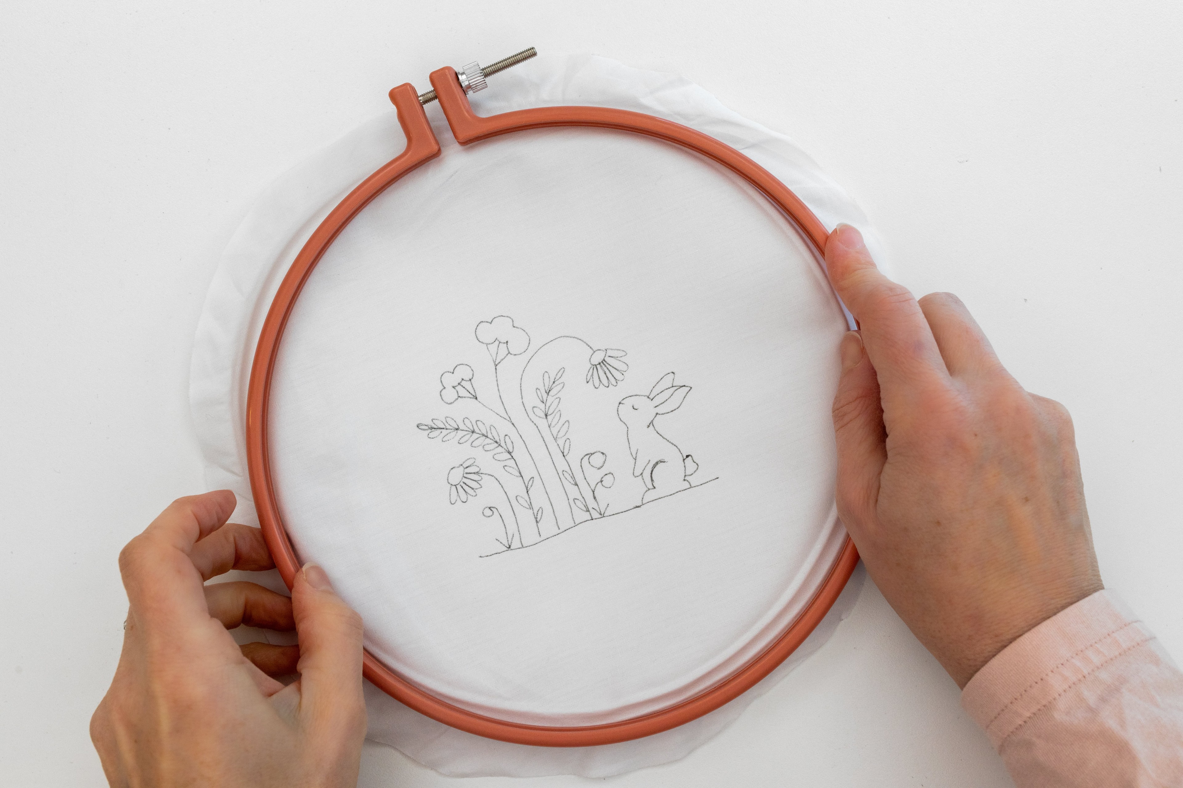 This is a san image of the Bunny Blooms pattern transferred onto embroidery fabric,