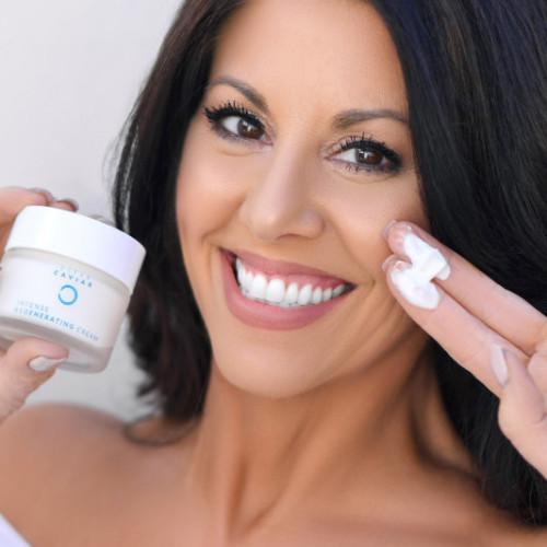 middle-aged woman holding up a jar of Noche's Ocean Caviar Face Cream.