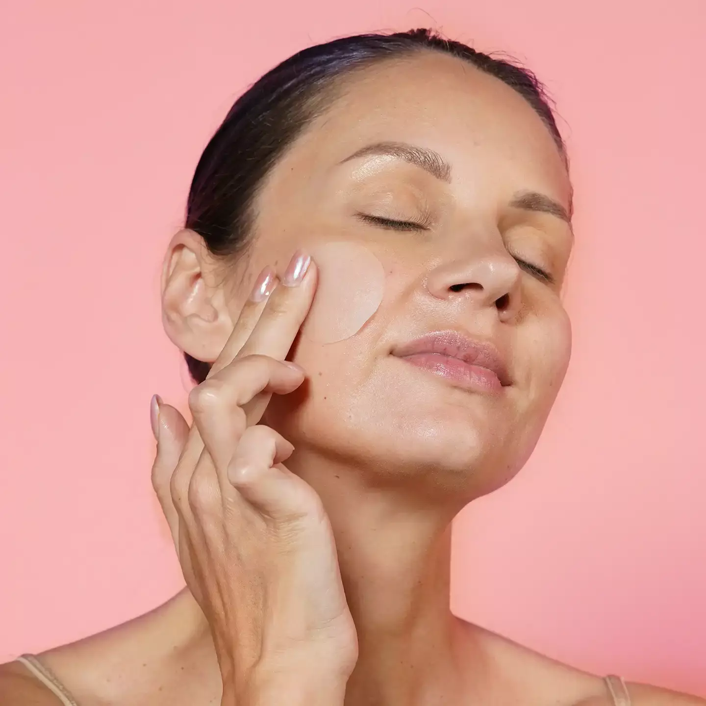 woman putting patch on face