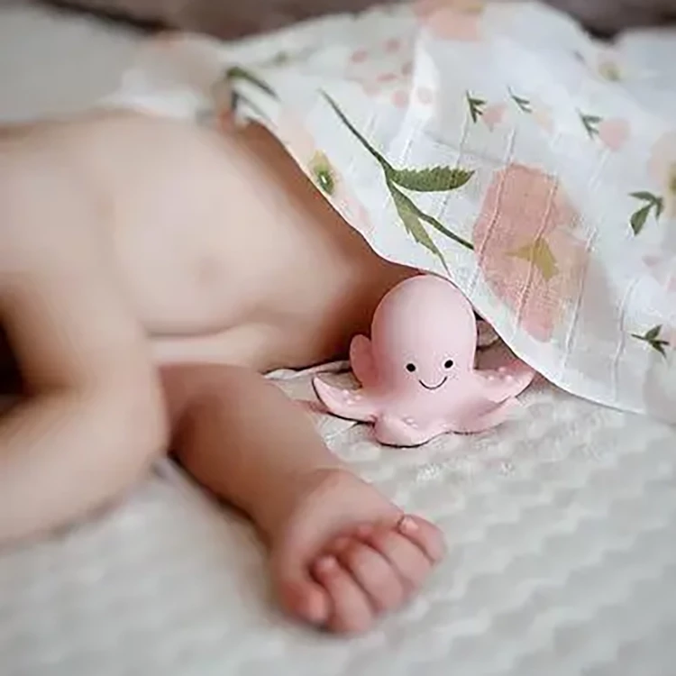 Baby sleeping with pink octopus toy