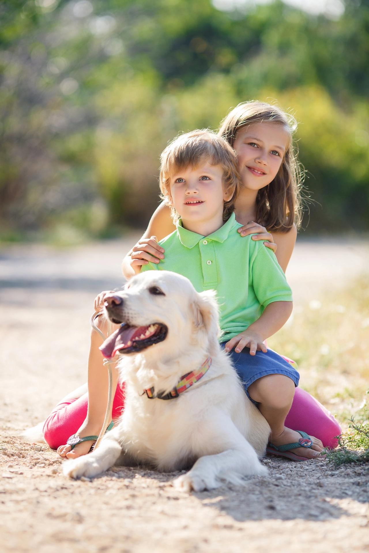 Girl and boy with labrador retriever
